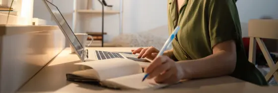 Developer working on laptop at home to Scrape Yelp data in Python for hospitality industry review analysis