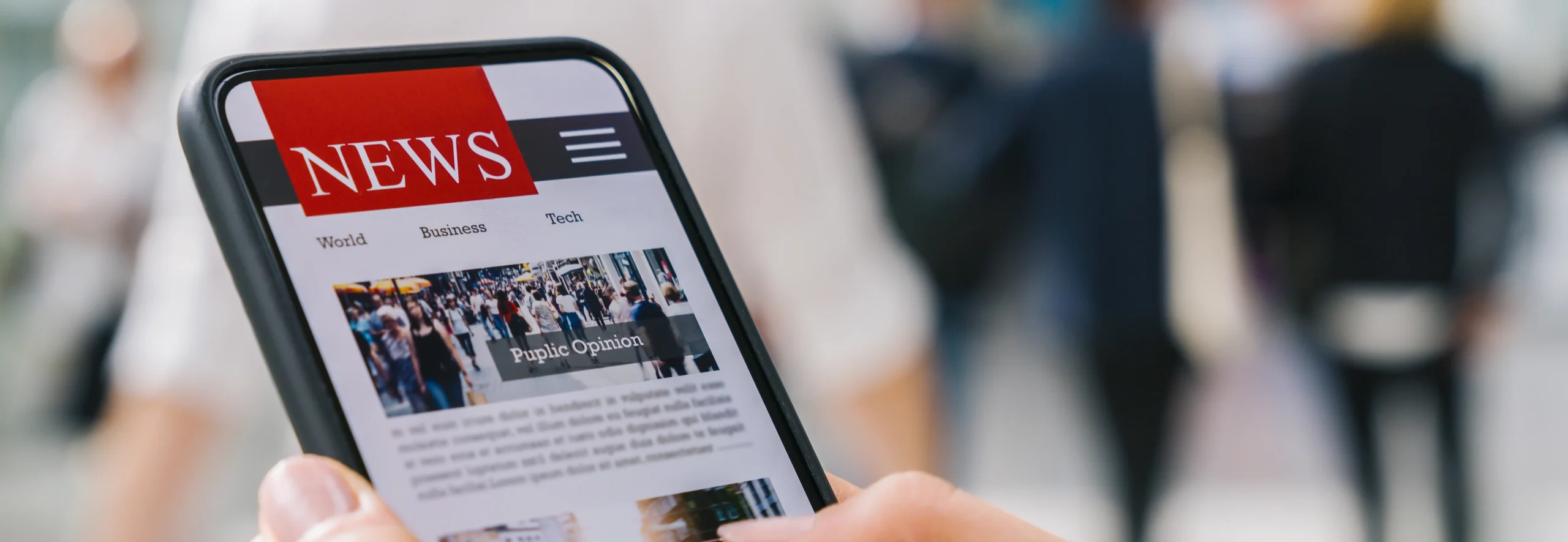News scraping and monitoring services - person reading news articles on smartphone with crowd in background