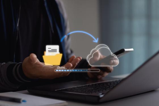 Professional demonstrating cloud scraping vs manual scraping with cloud storage data transfer visualization