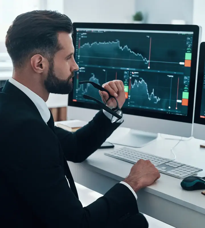 Stock market data scraping results reviewed by two analysts on shared screens